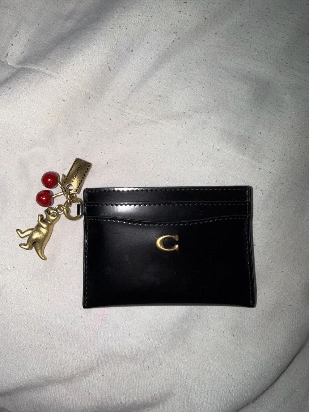 Coach black spazzolato card case wallet with charms